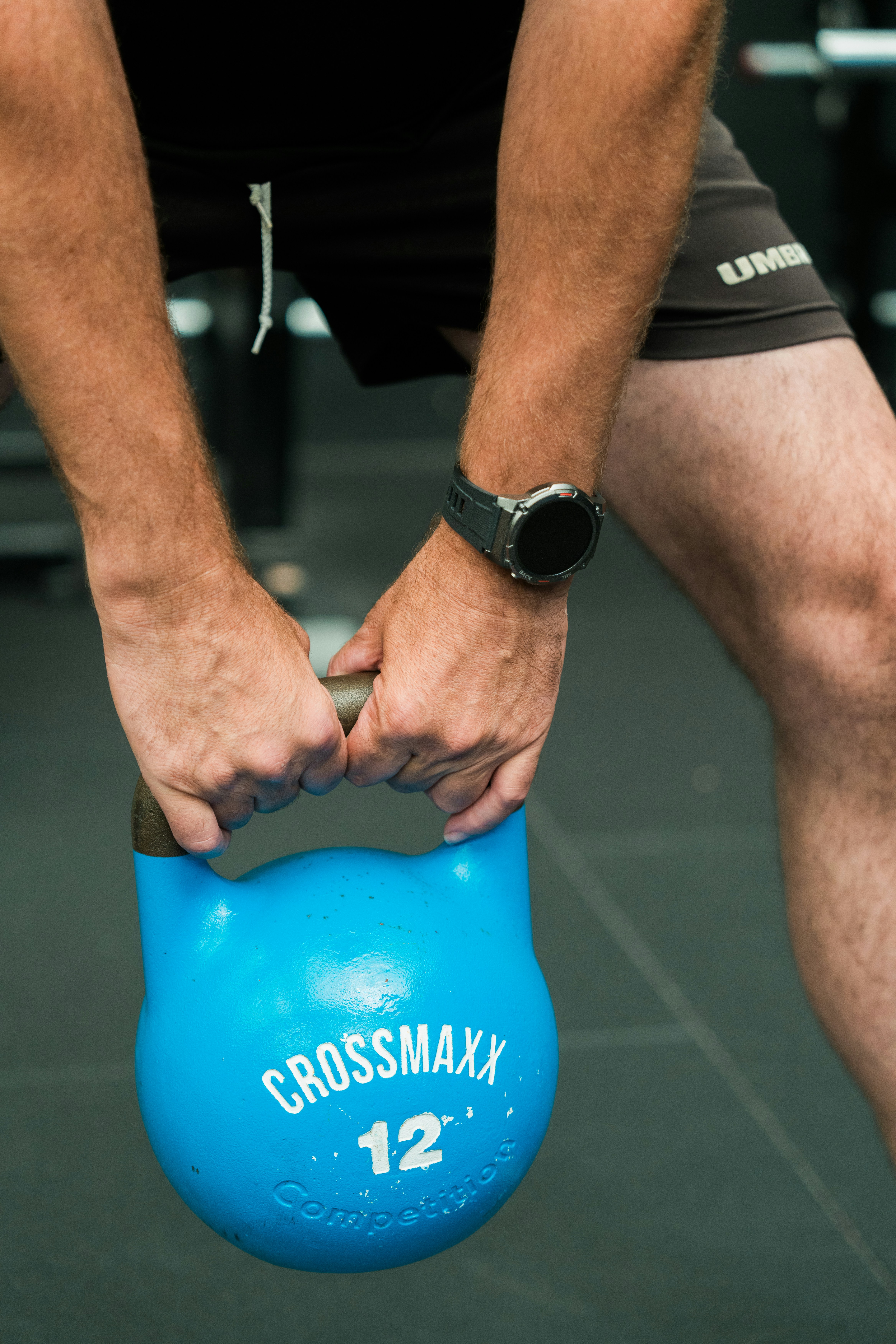A man is holding a blue exercise ball