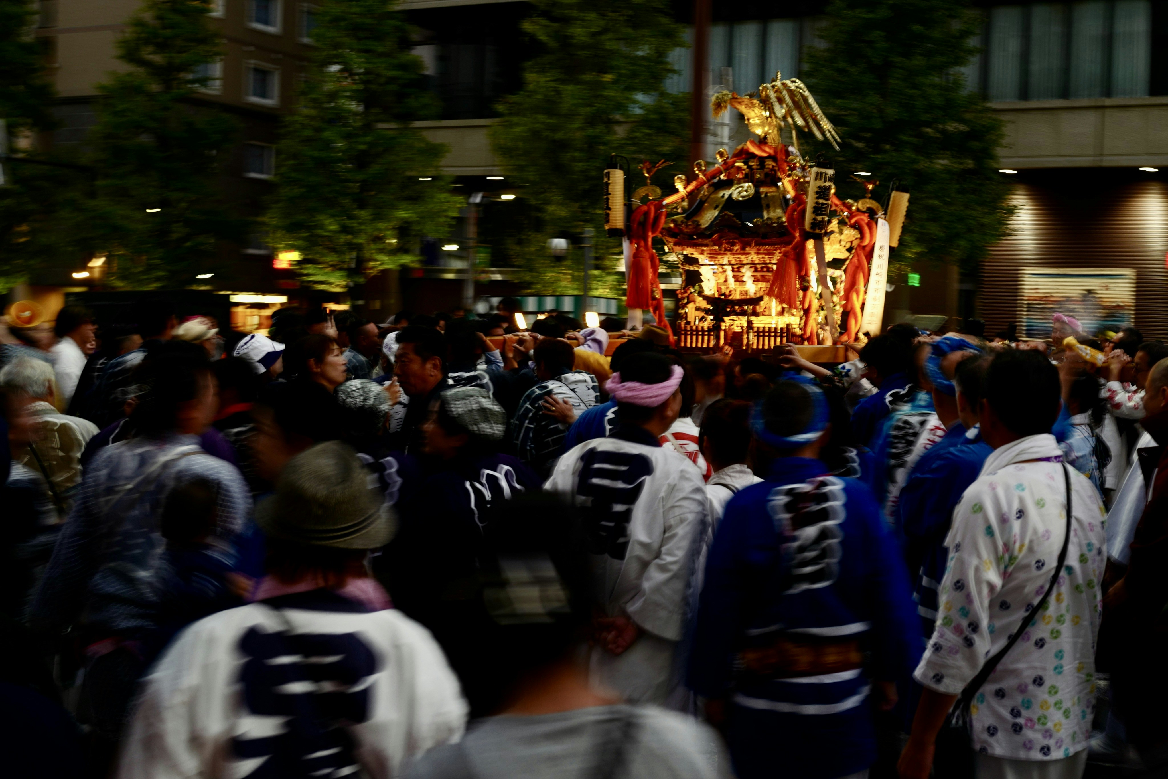 A large group of people walking down a street