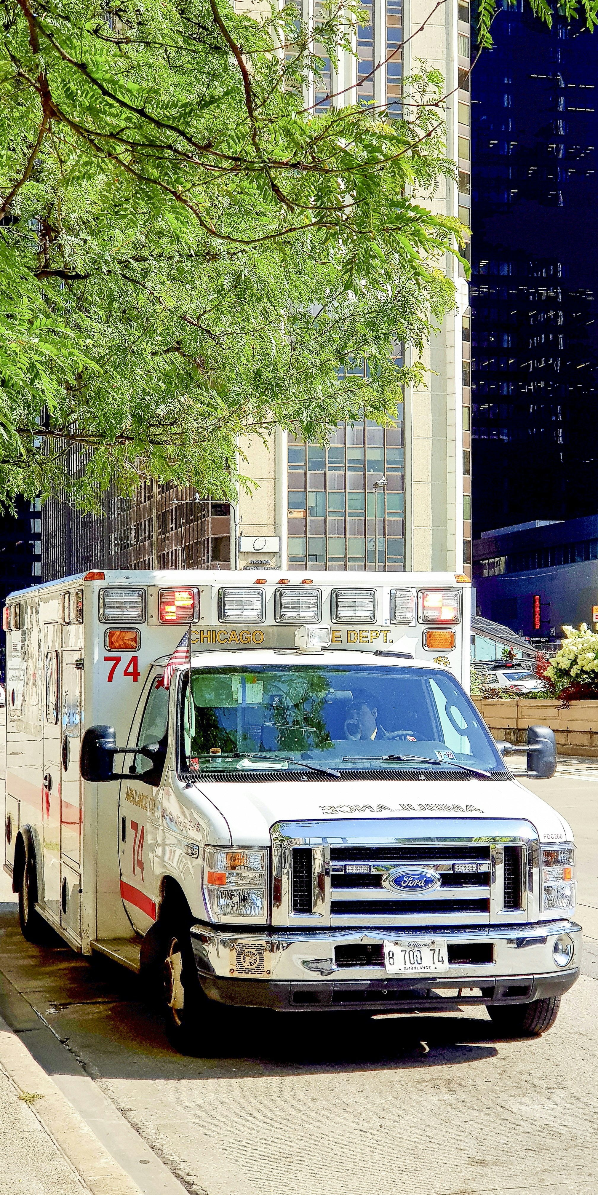 Modern ambulance vehicle on bright urban Indian road, daytime