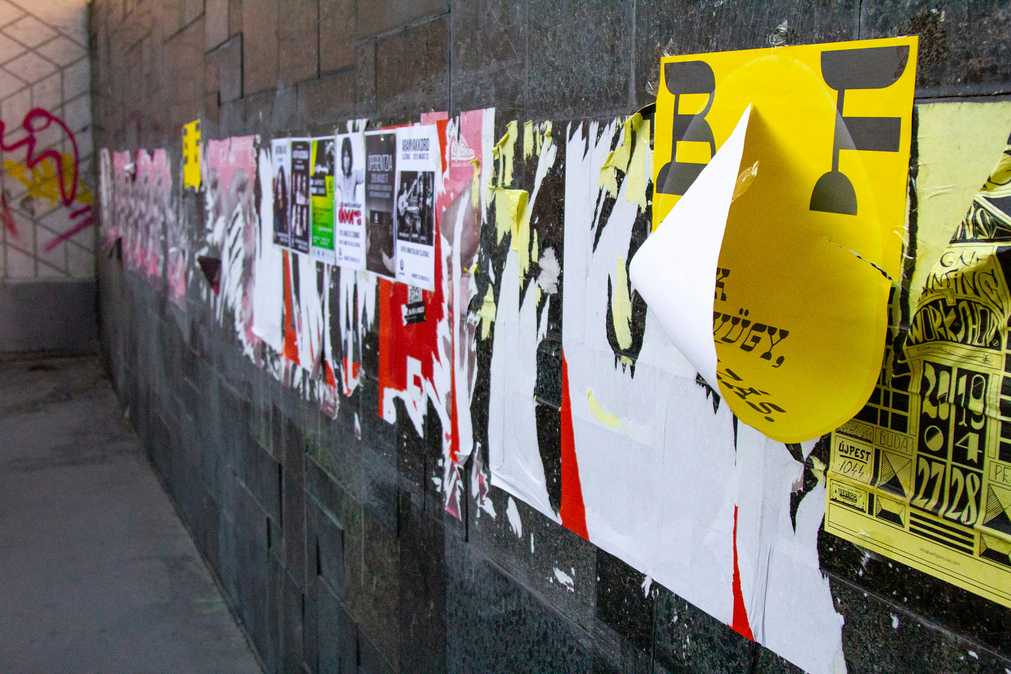 A wall with a bunch of posters on it