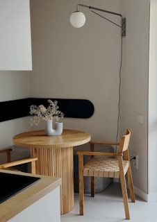 A room with a table, chair, and lamp