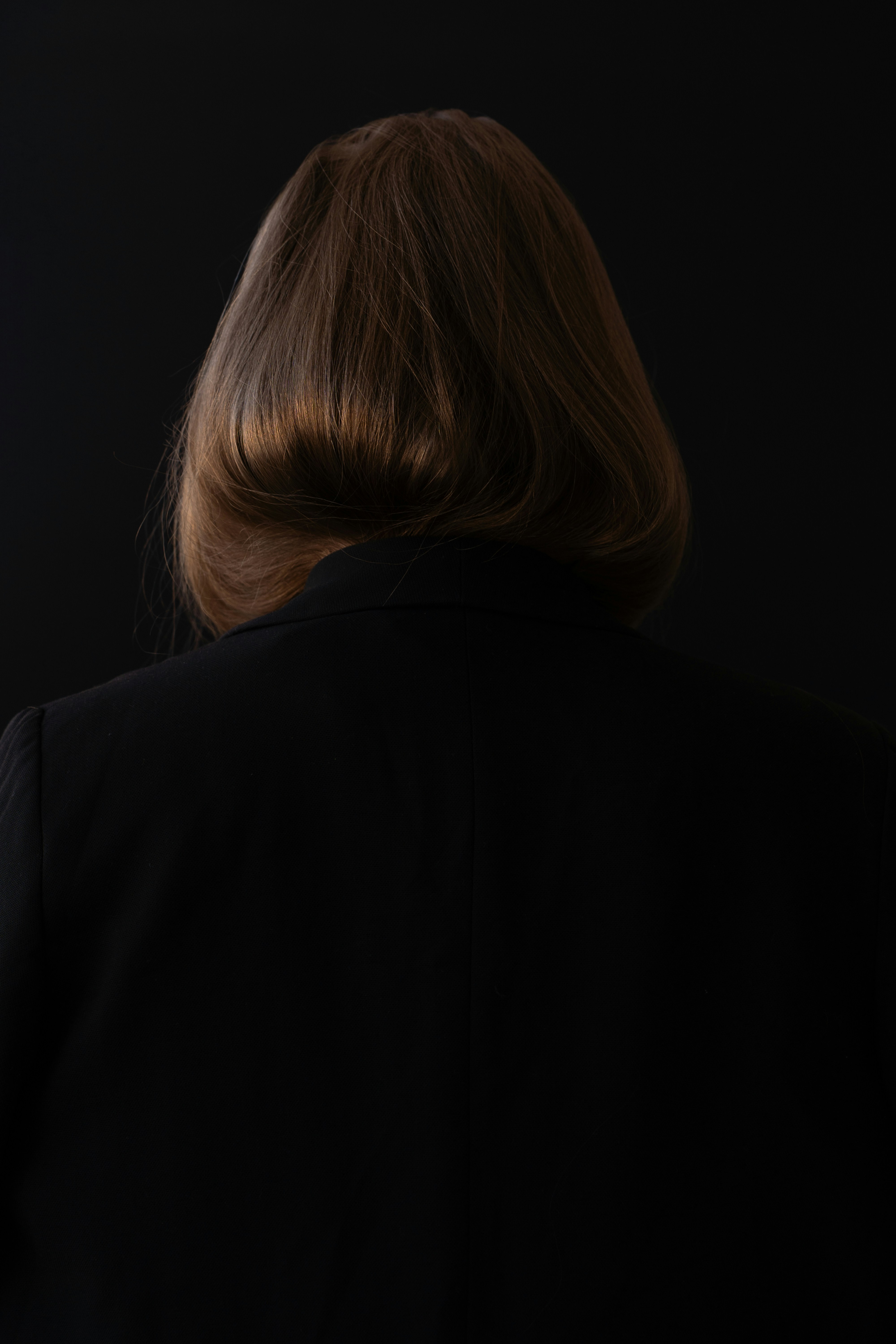 A woman standing in front of a black background