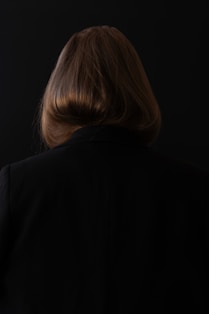 A woman standing in front of a black background