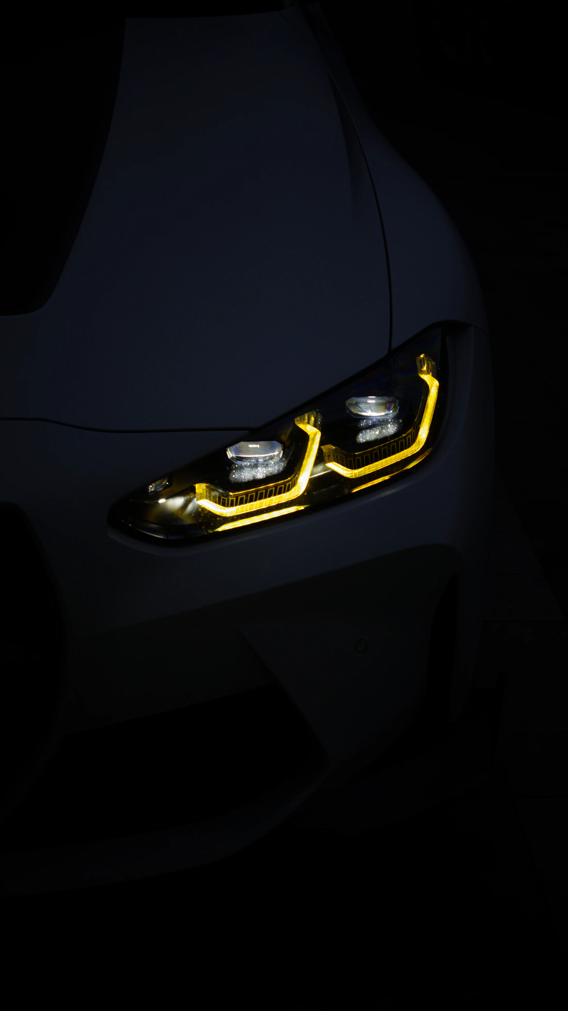 A car headlight glowing in the dark
