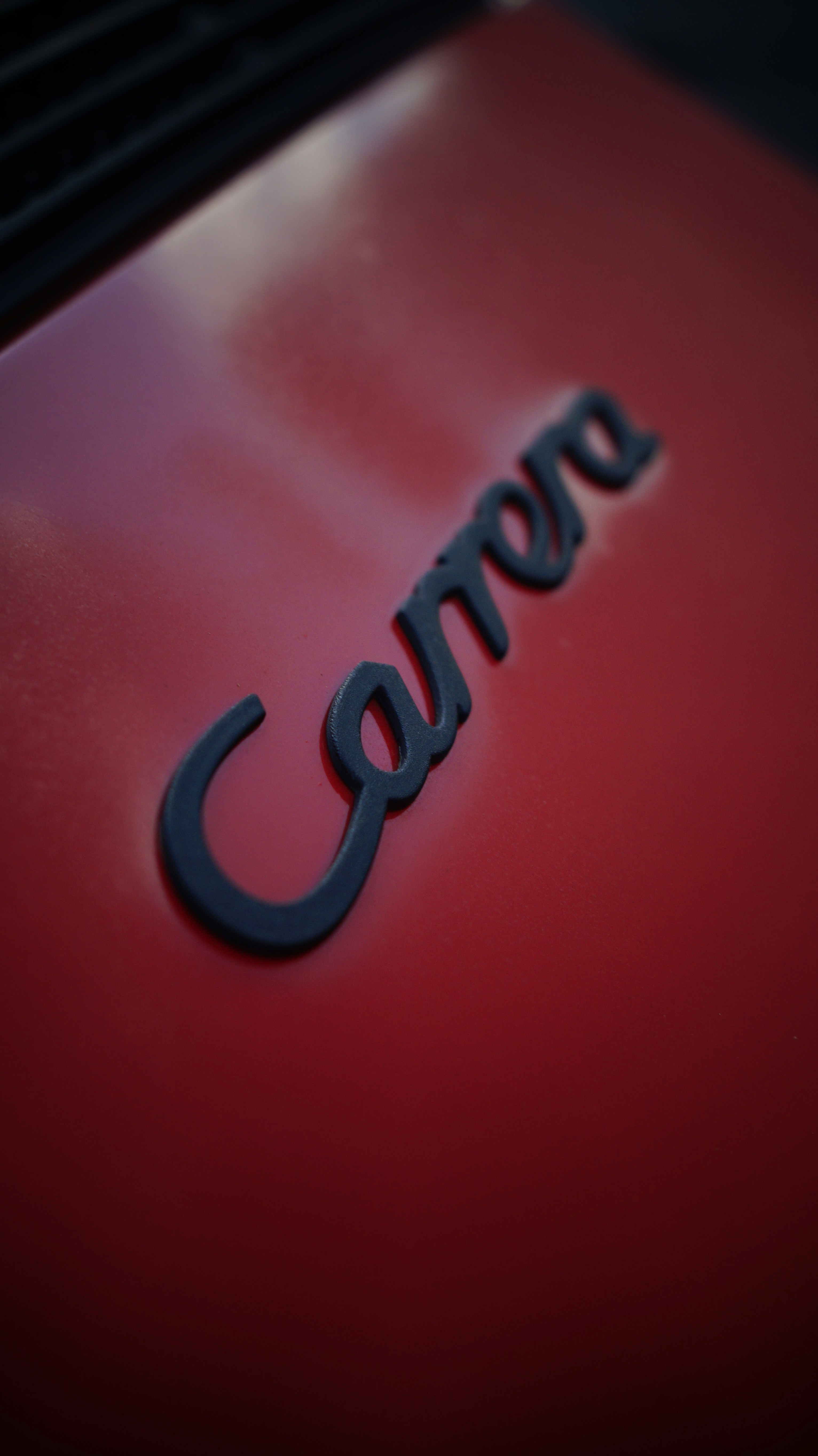 A close up of a red car with the word camera on it