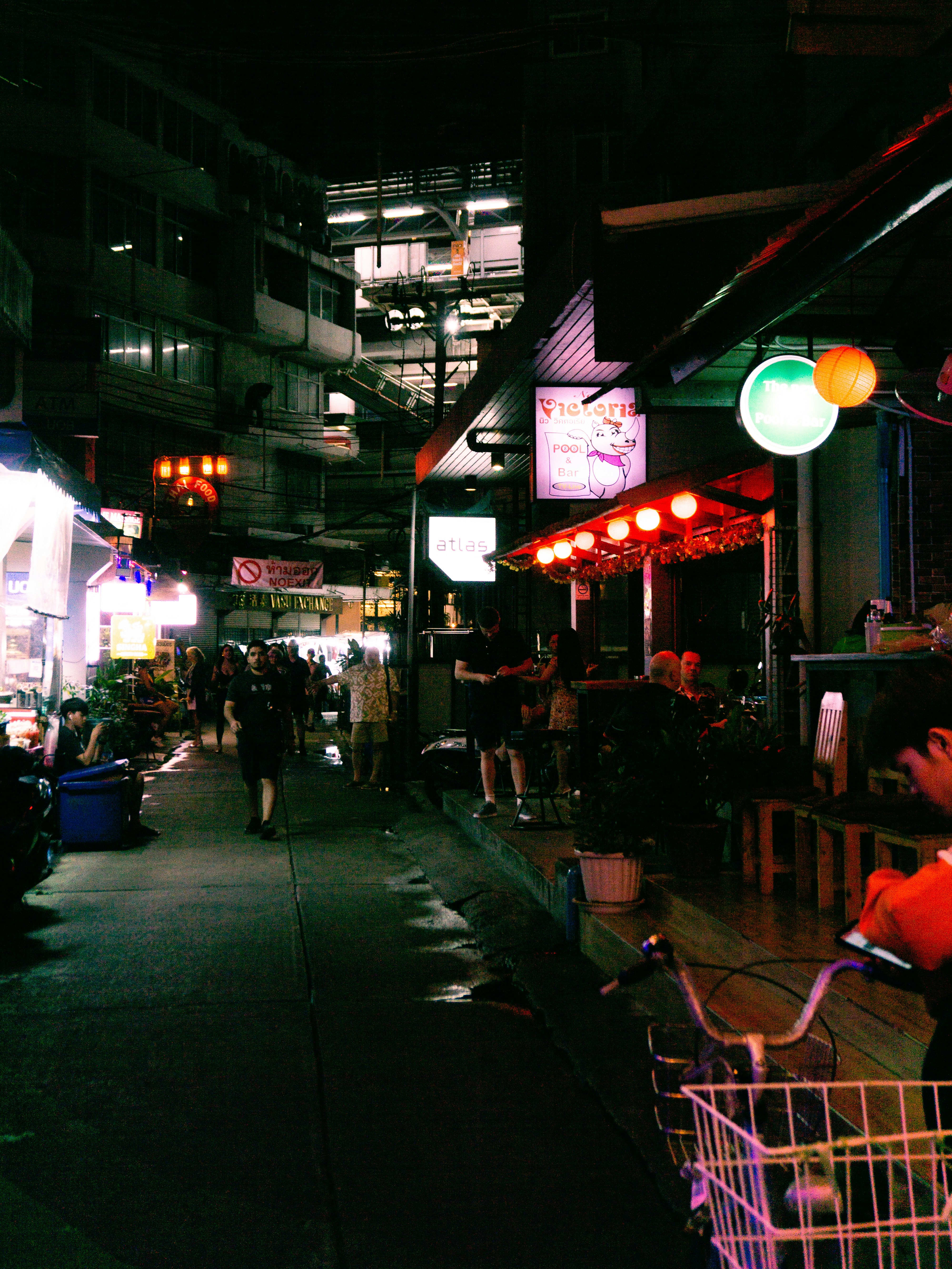 A shopping cart is parked on the side of the street