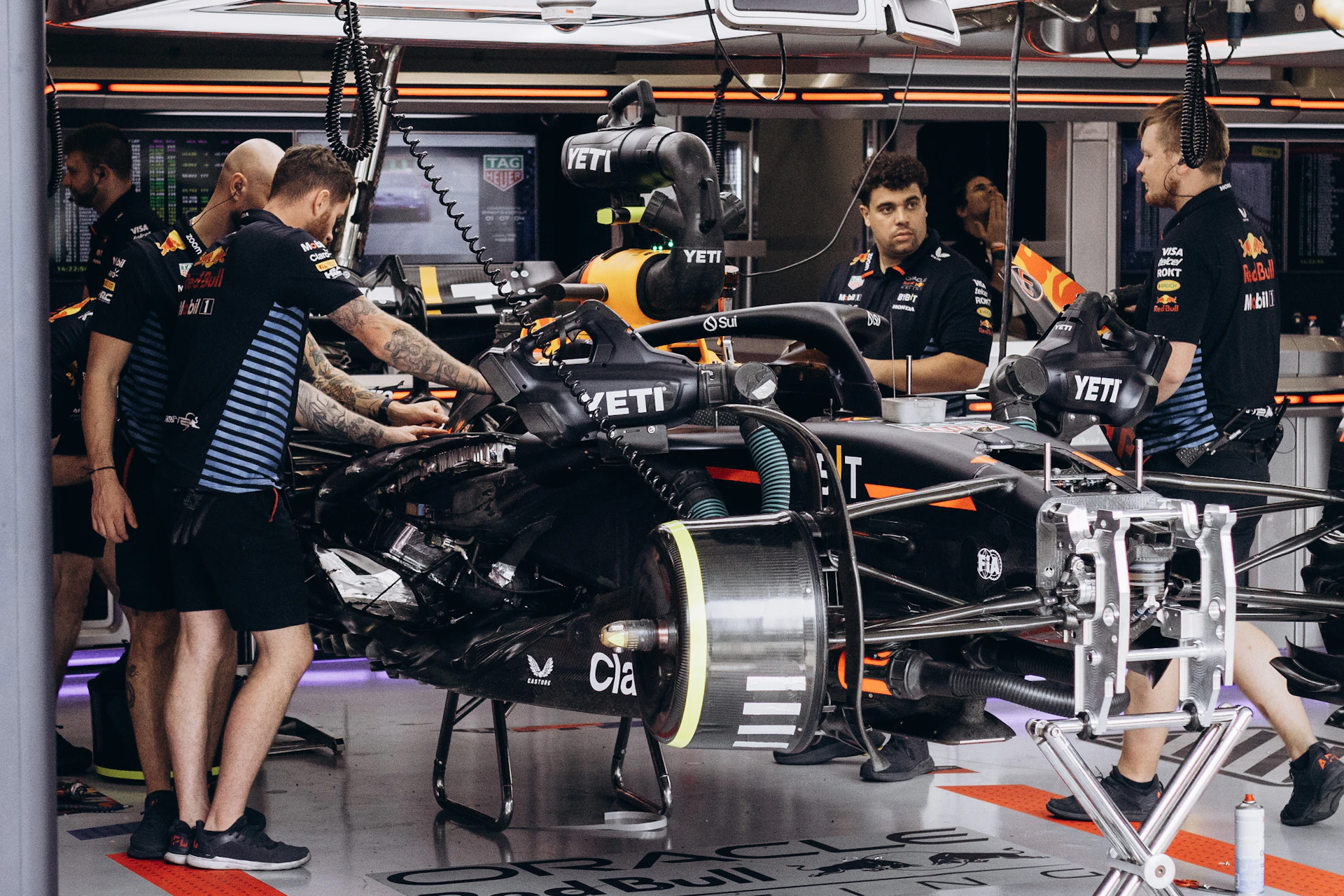 A group of mechanics working on a car