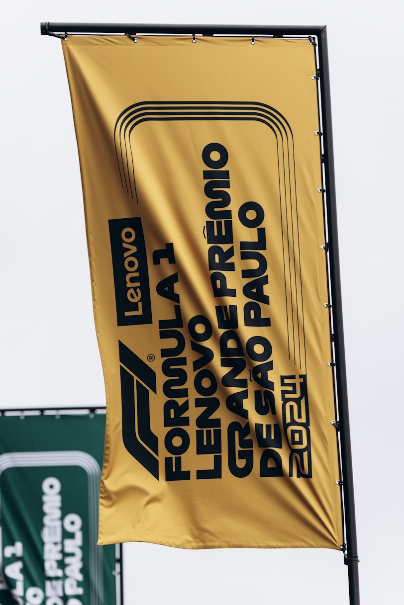 A large yellow sign hanging from the side of a building