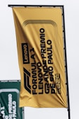 A large yellow sign hanging from the side of a building