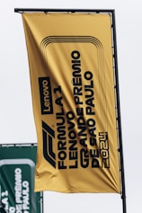 A large yellow sign hanging from the side of a building