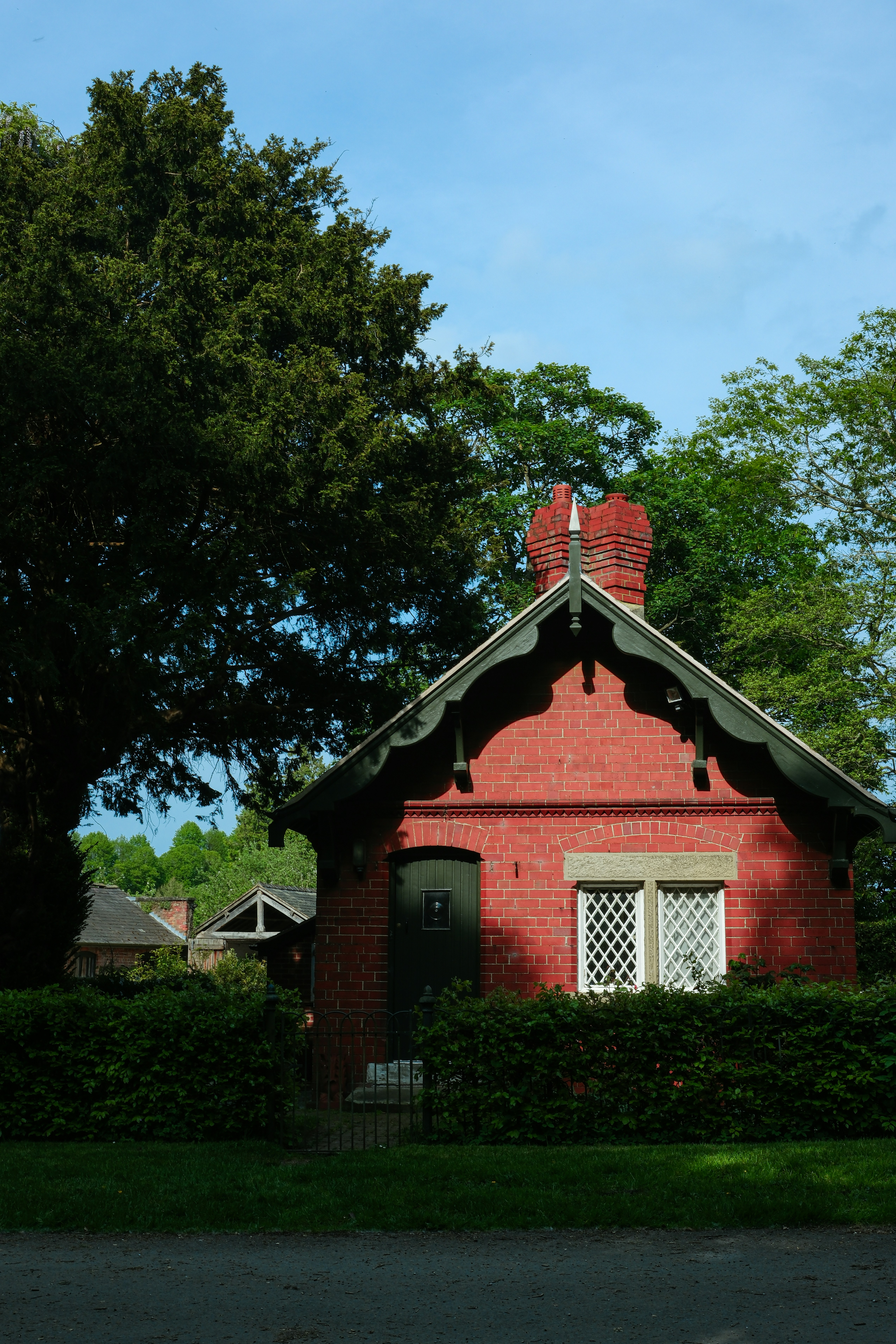 A red brick house with a green roof