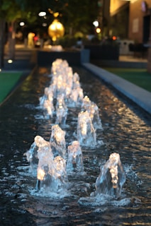 A group of water fountains in the middle of a street
