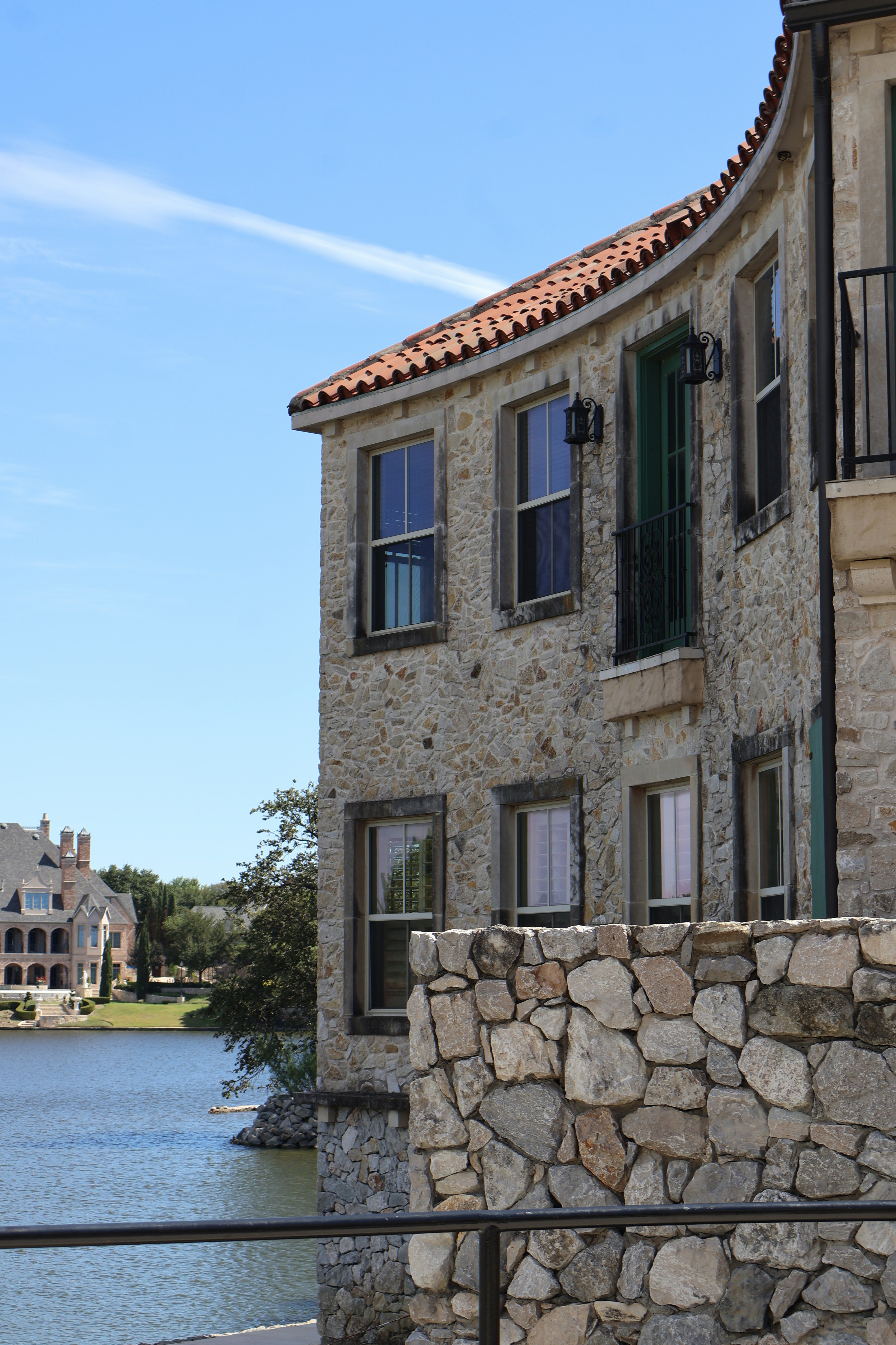 A stone building next to a body of water