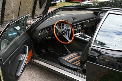 A black car with a red steering wheel