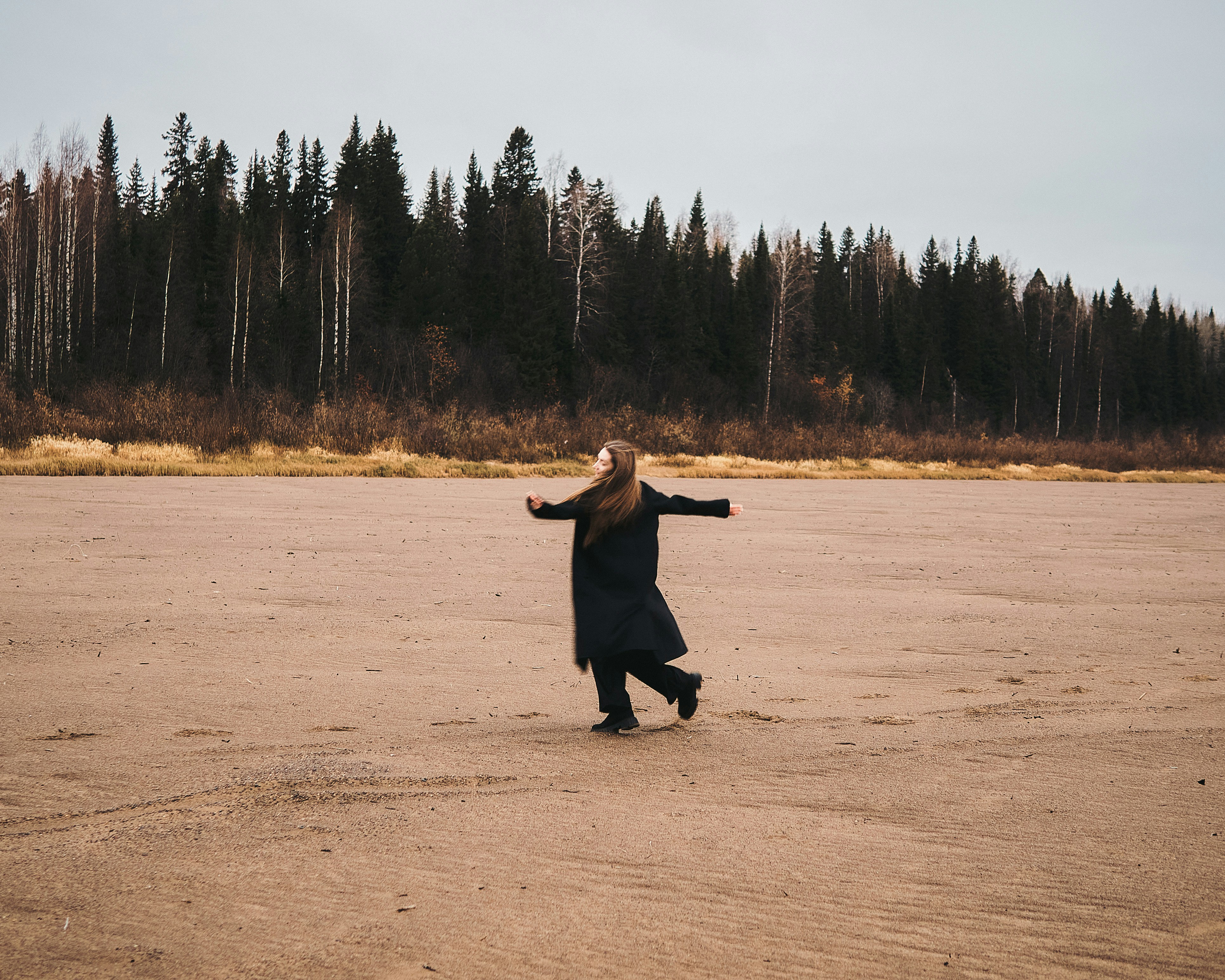 A person in a field with trees in the background