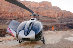 A helicopter is parked on the side of a mountain