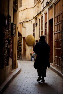 A person walking down a narrow alley way