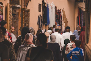 A crowd of people walking down a narrow street