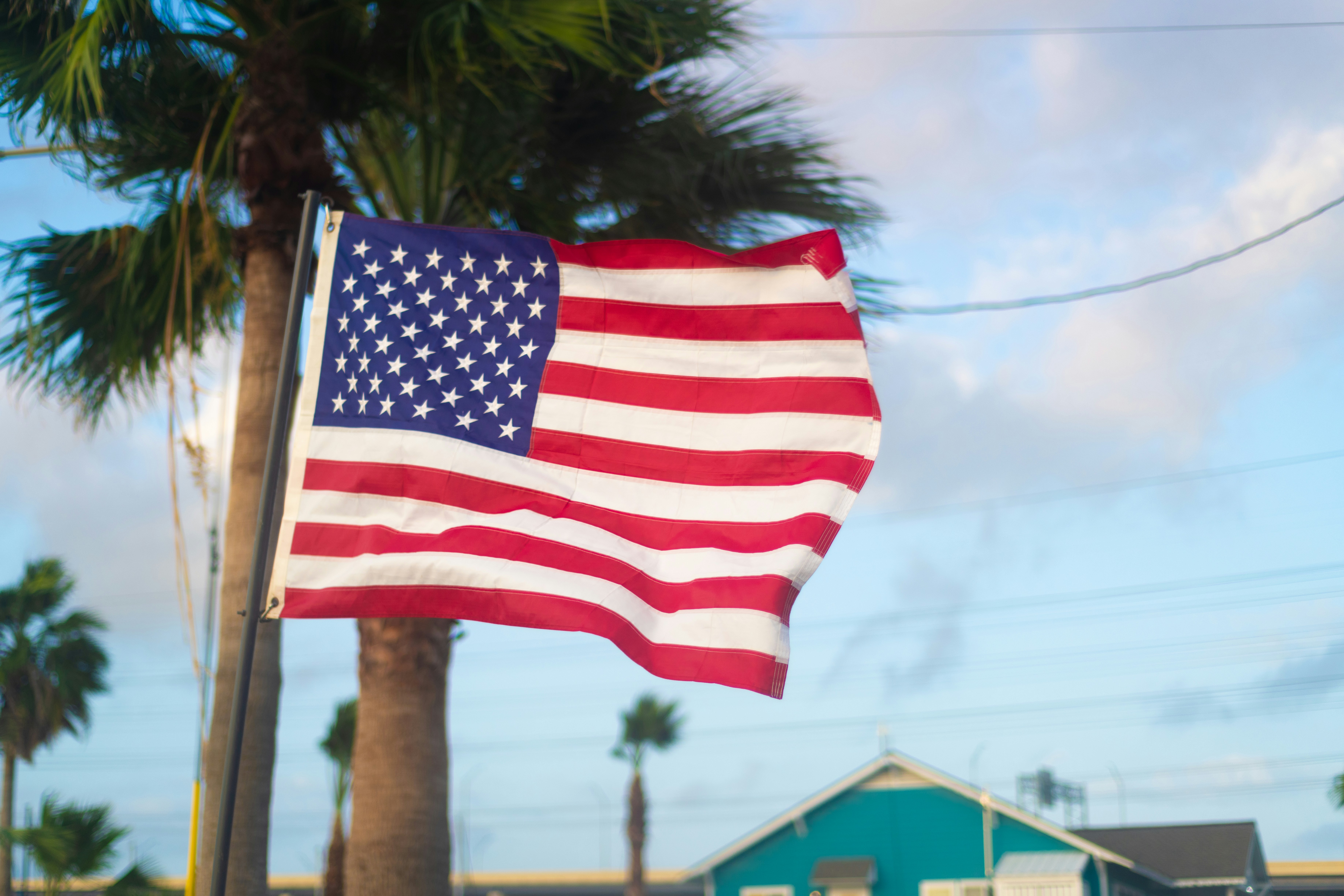 A large american flag flying in the wind