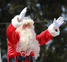 A man dressed as santa claus waves to the crowd