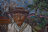 A painting of a man with a hat and a cane
