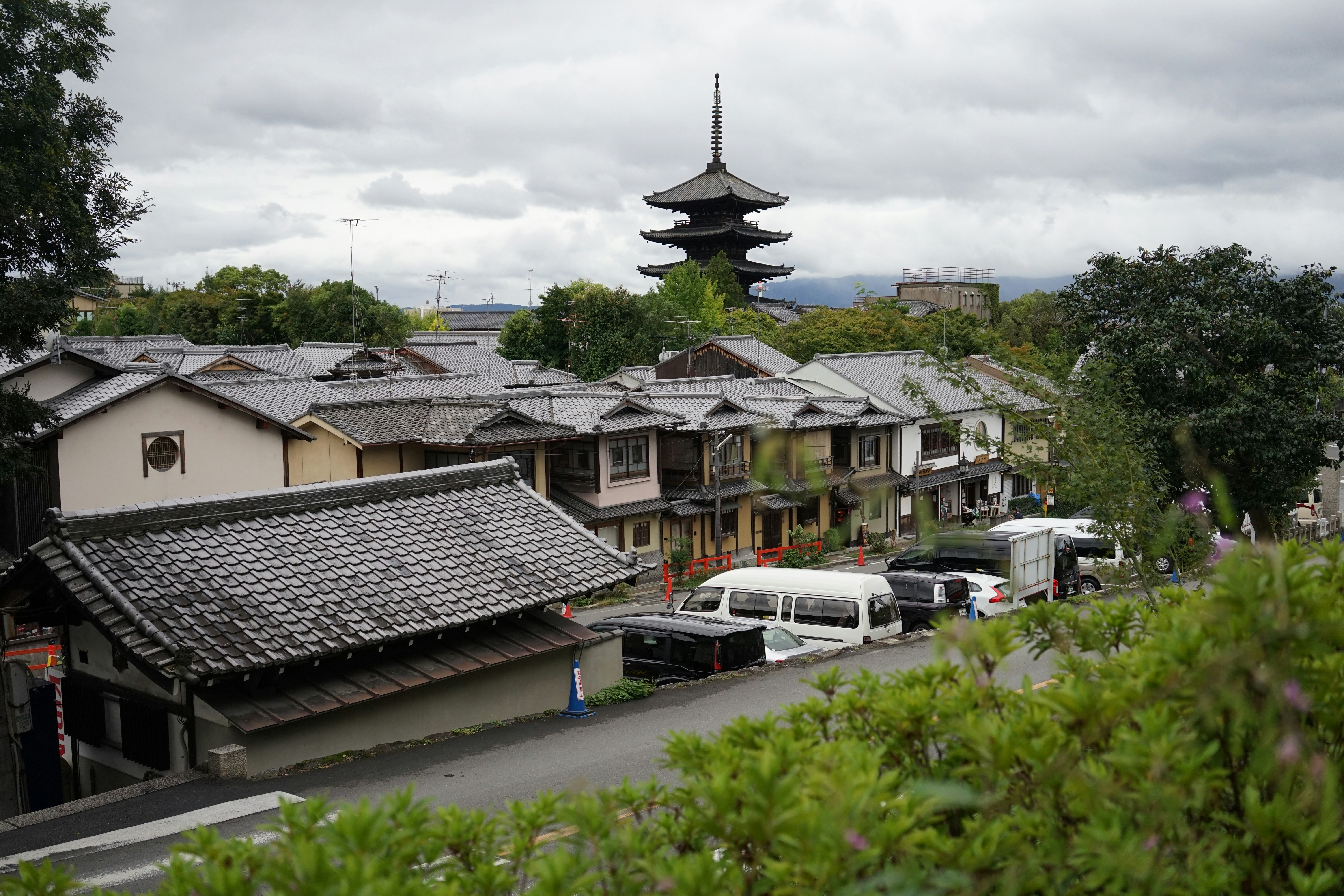 A row of houses with a pagoda in the background