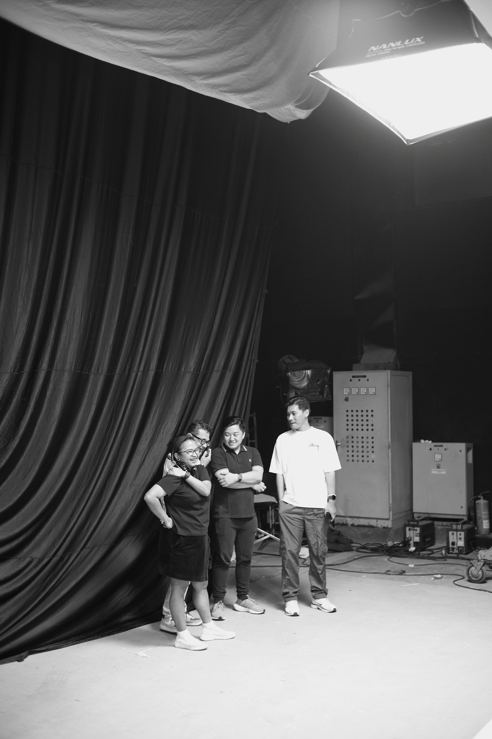 Theatre rehearsal space with dramatic lighting and performers