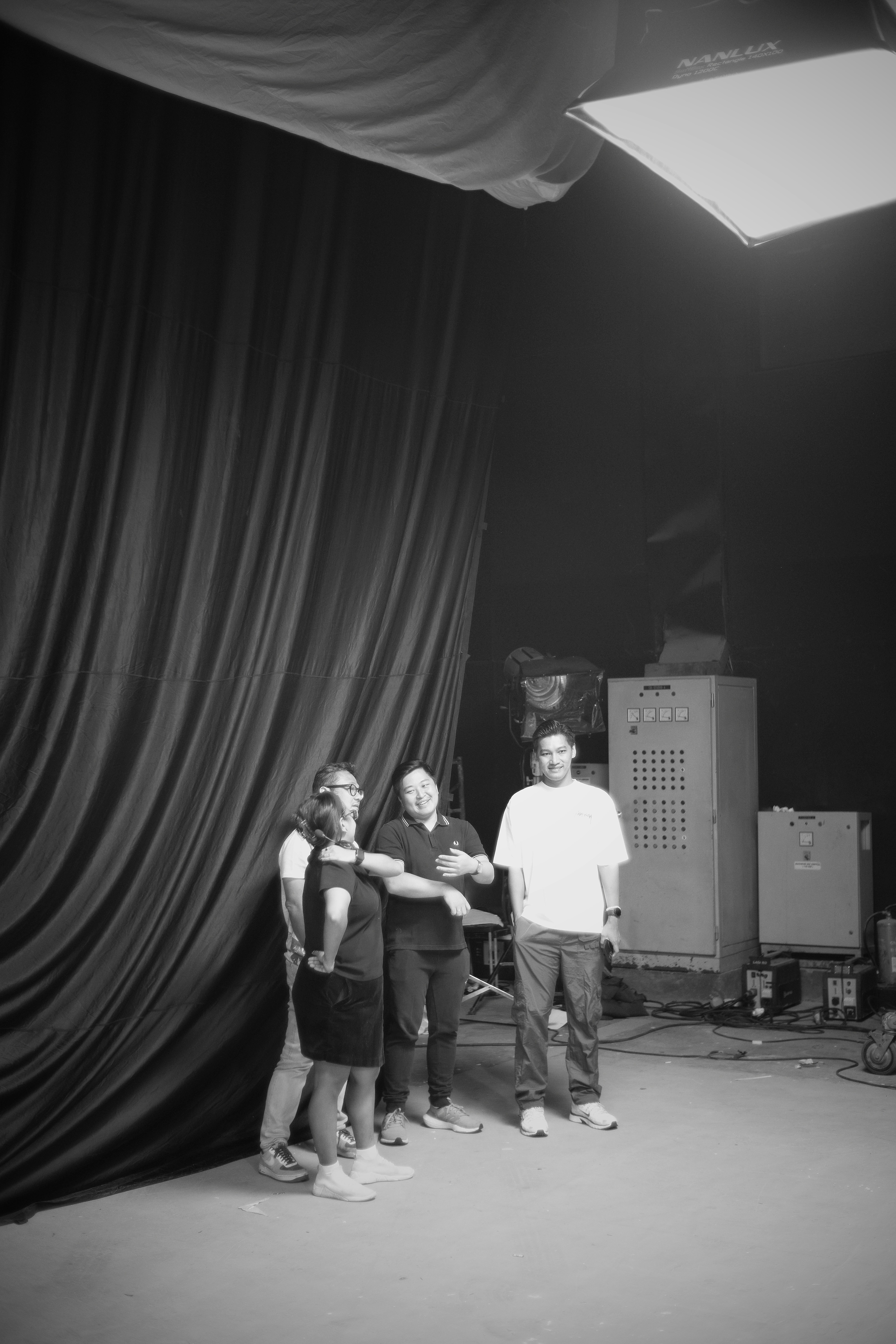 A group of people standing in front of a black curtain