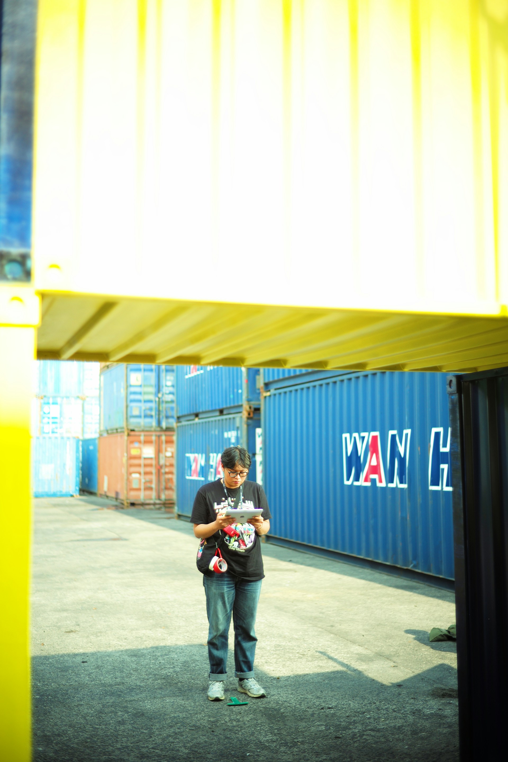 A man standing in front of a blue container