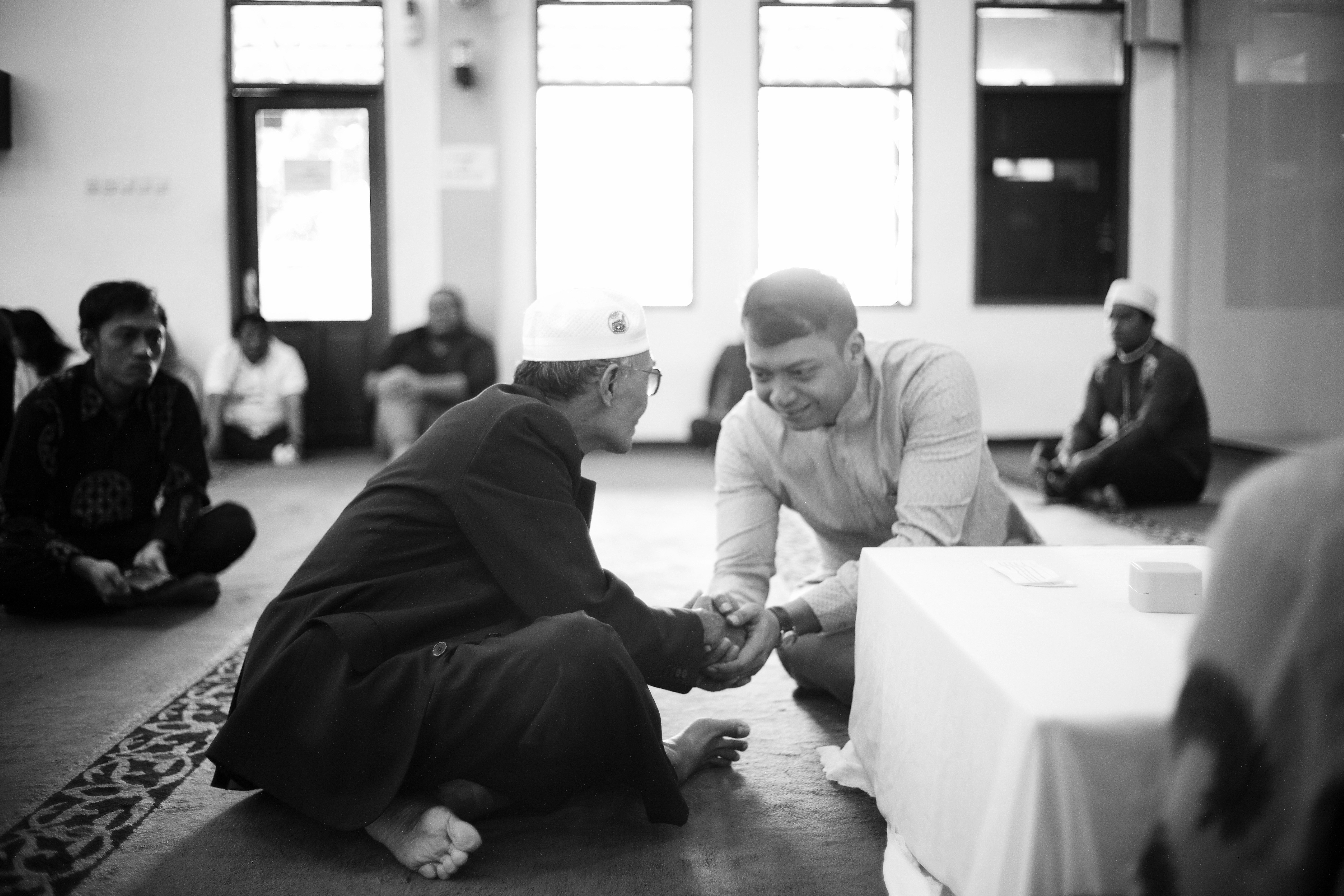 A group of people sitting on the floor in a room