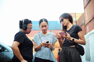 A group of three women standing next to each other