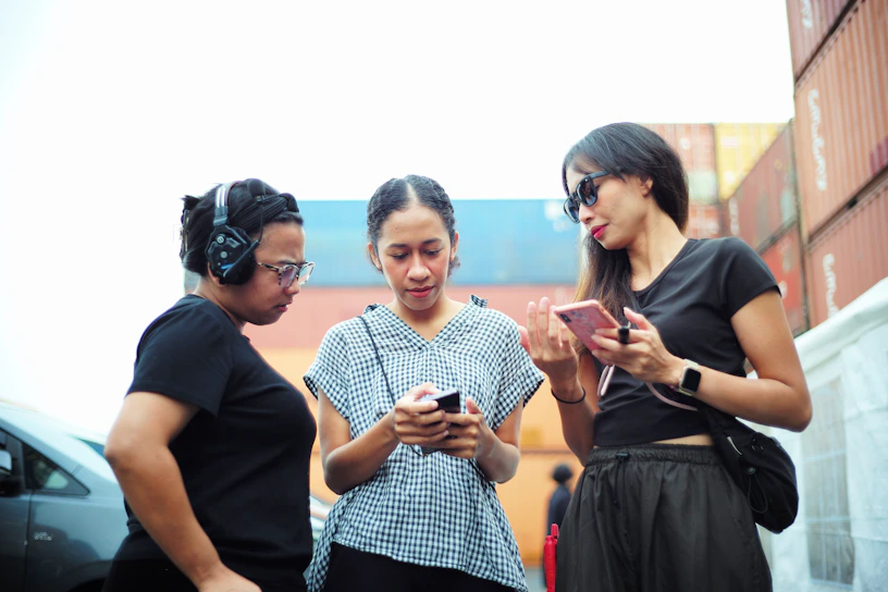 A group of three women standing next to each other