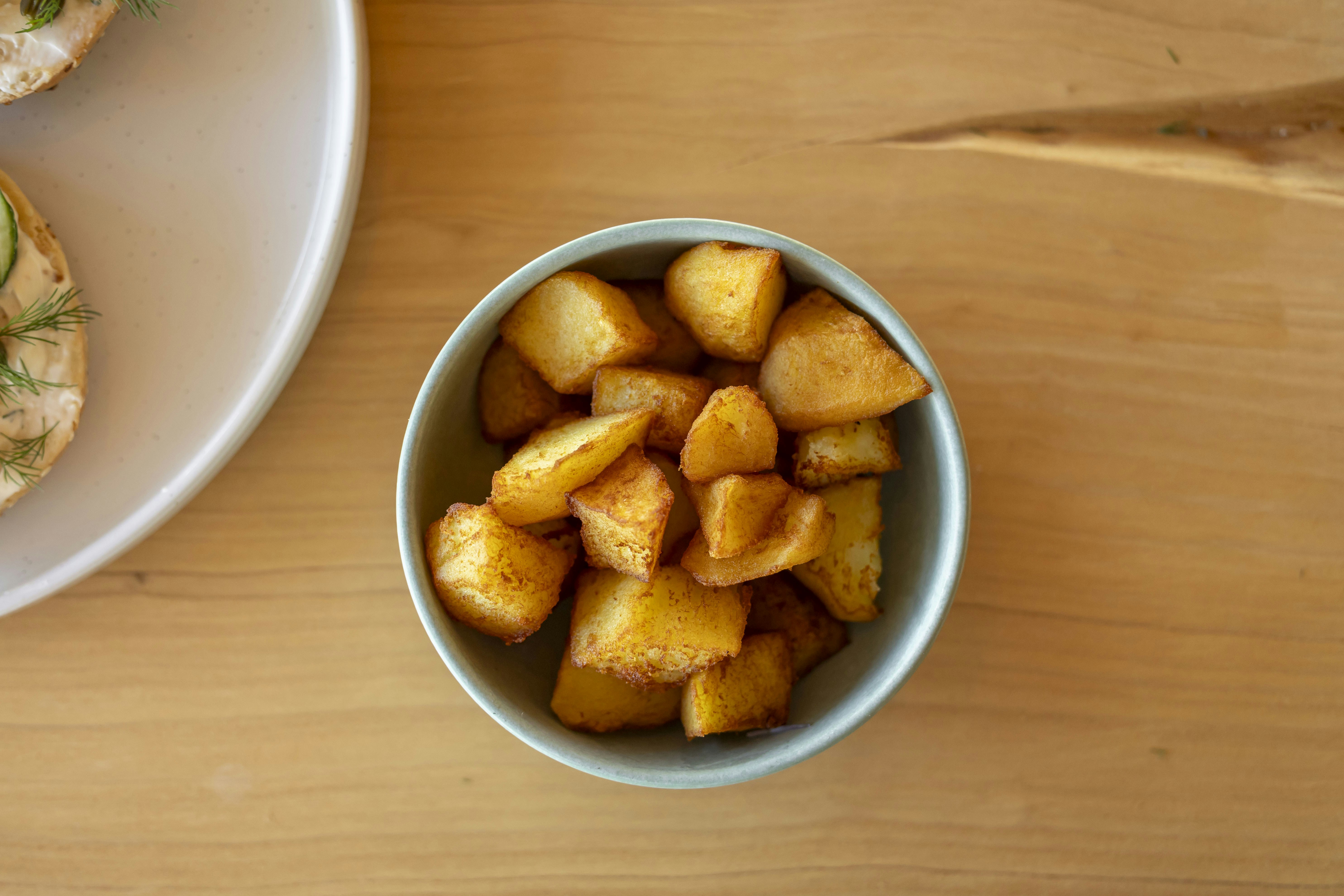 A plate of food and a bowl of food on a table