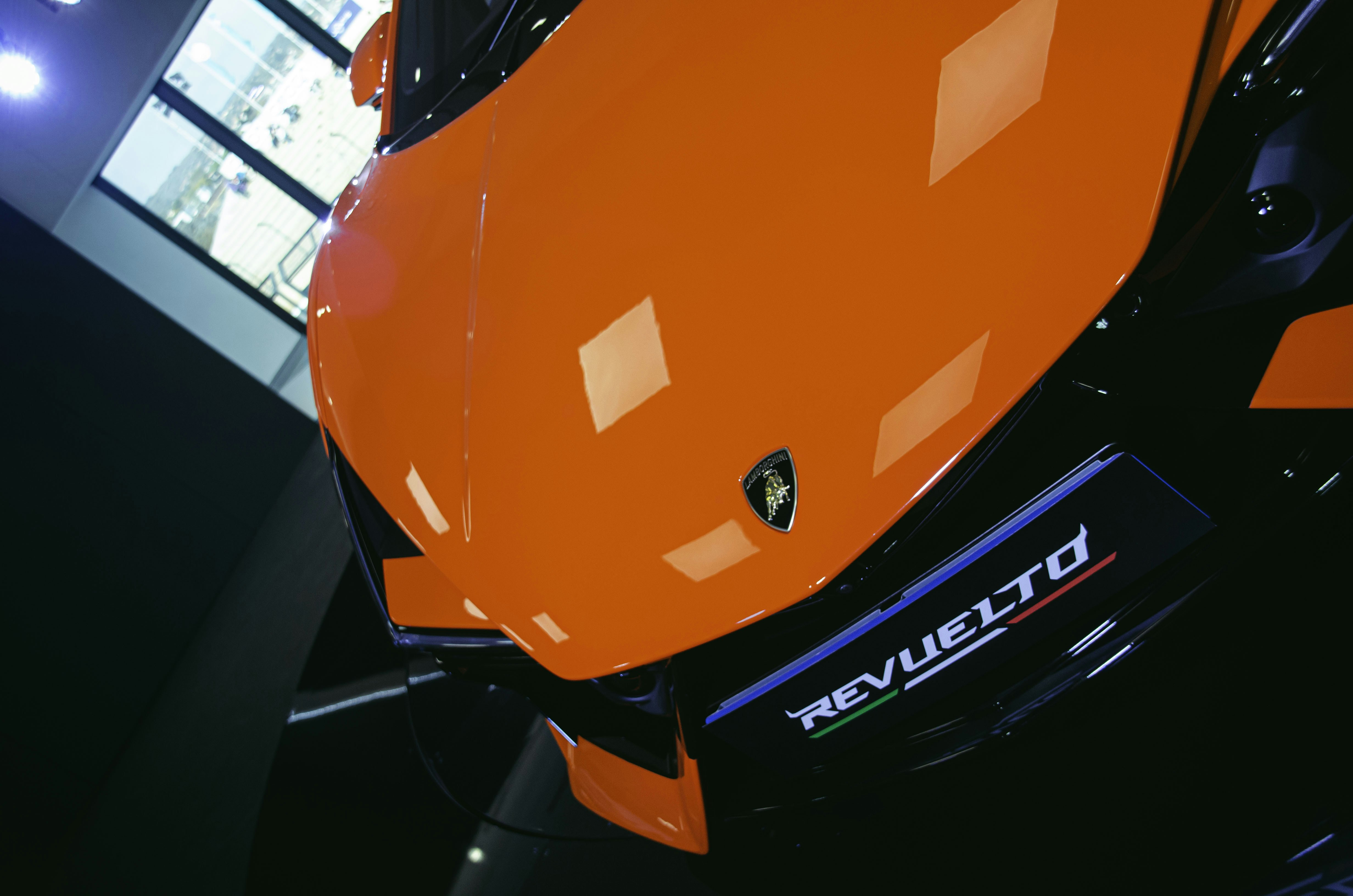 An orange motorcycle parked inside of a building