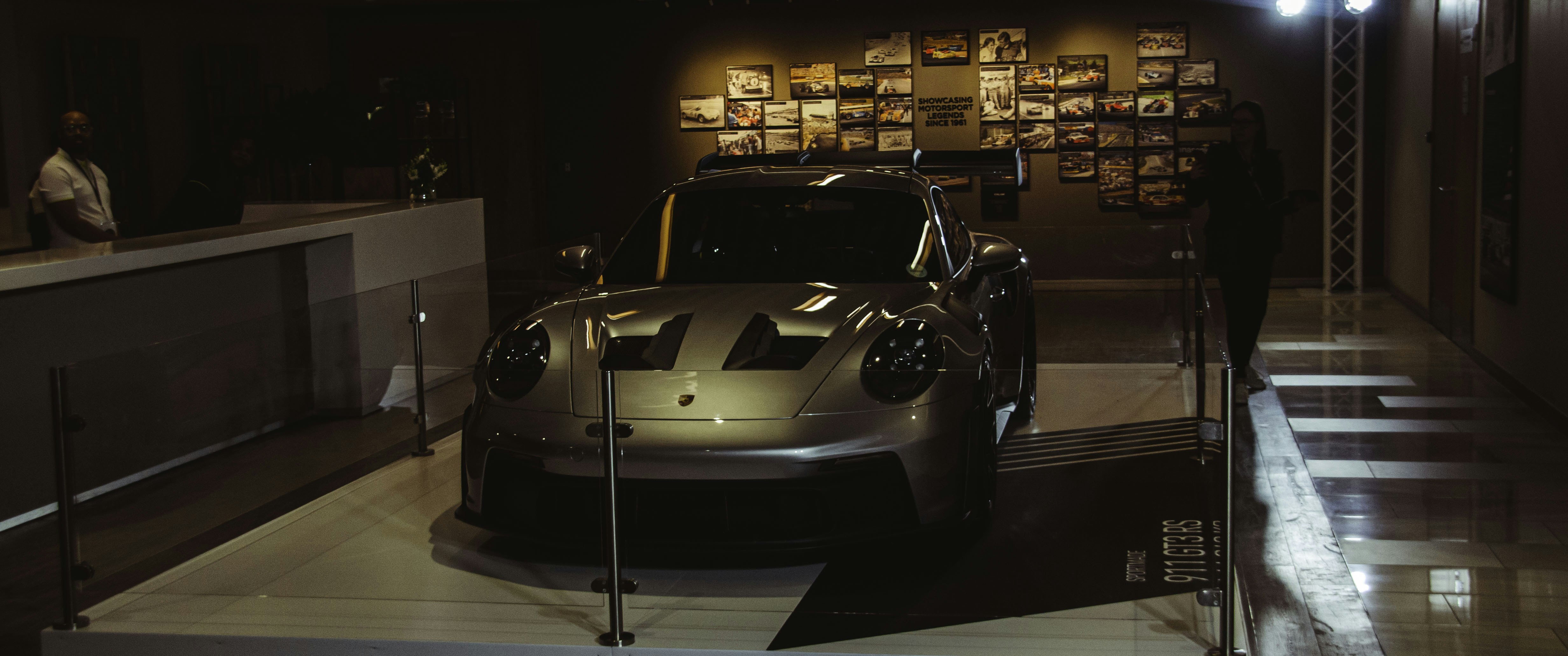 Porsche sports car inside a high-tech garage environment