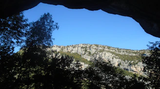 A view of a mountain through a cave
