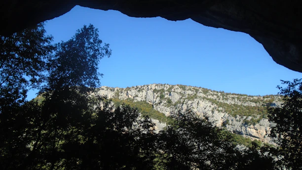A view of a mountain through a cave