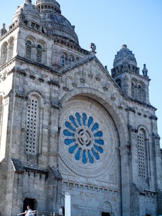 A large cathedral with a massive clock on it's side