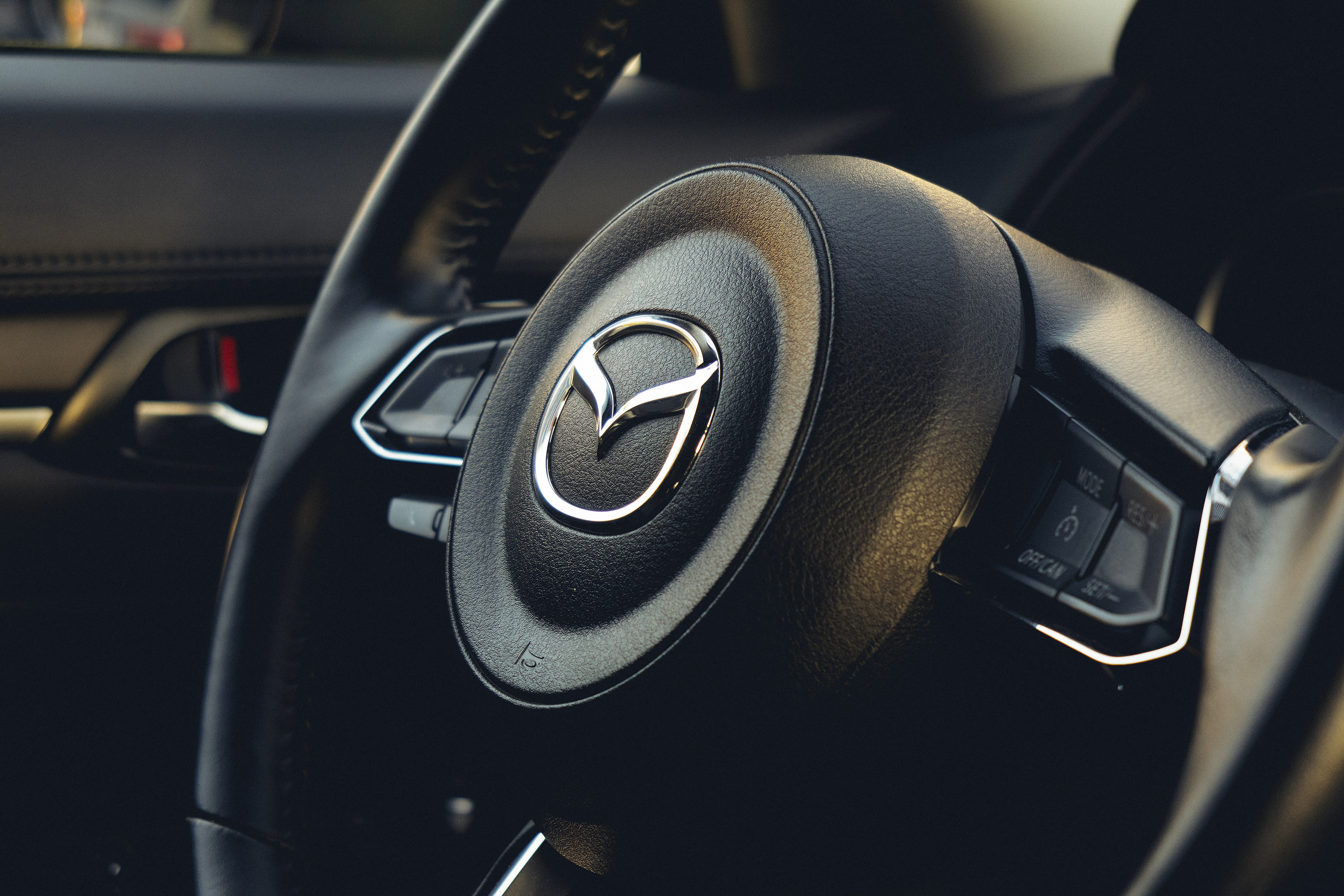 A steering wheel and dashboard of a car