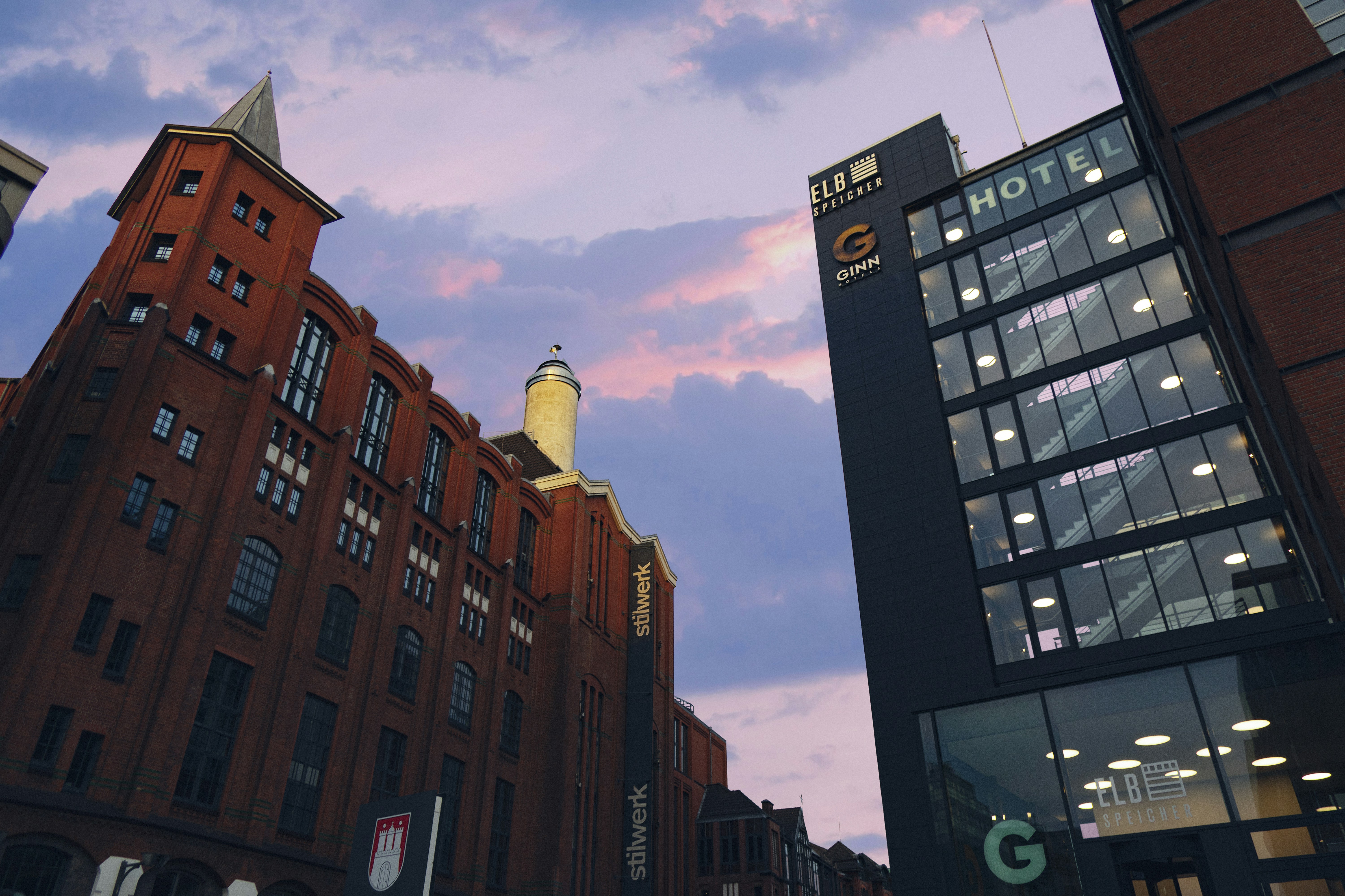 A city street with tall buildings and a sky background