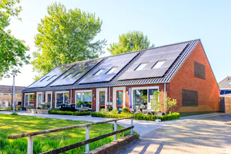 A house with a lot of solar panels on the roof