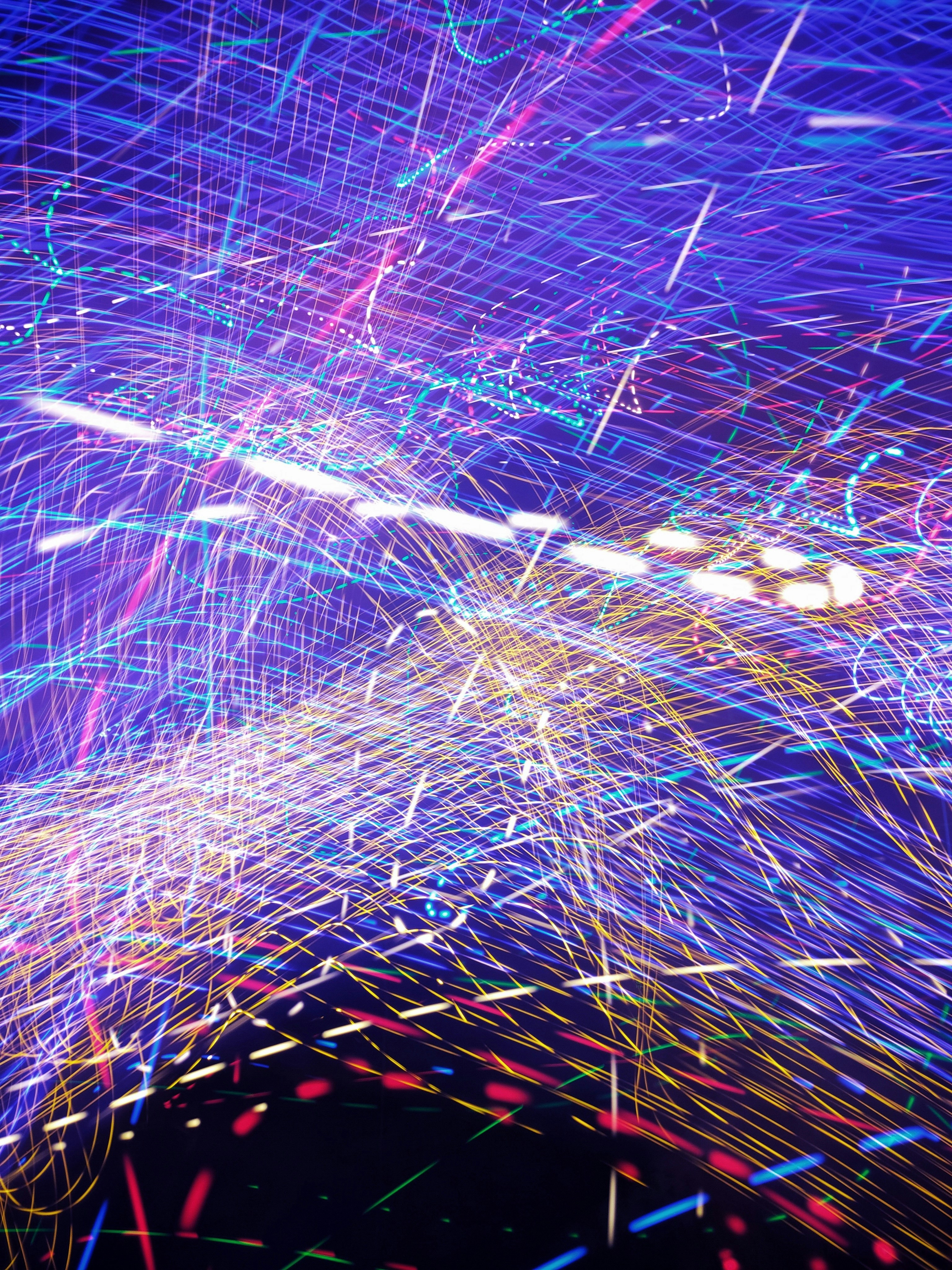 A blue and purple background with lots of light streaks