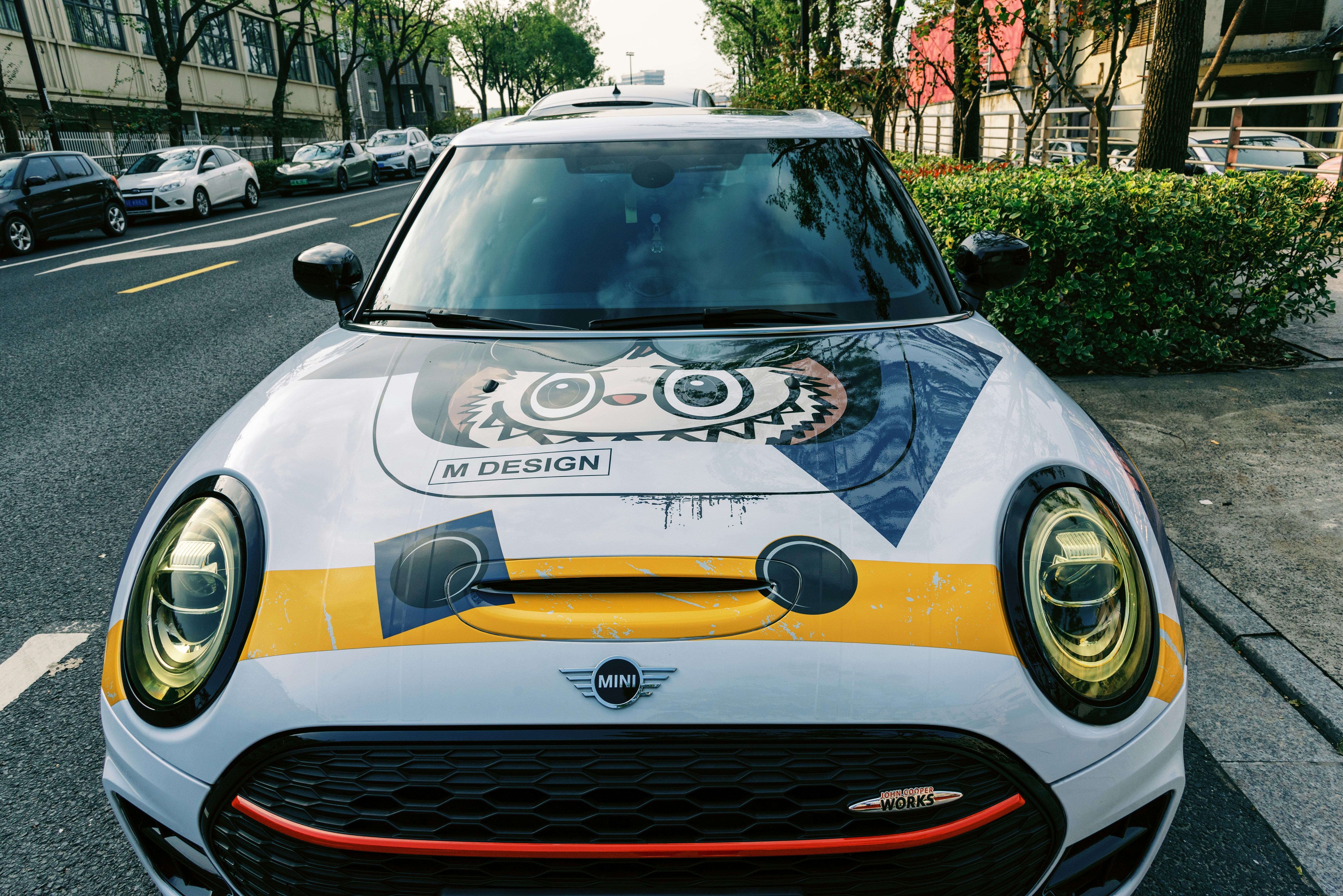 A white and yellow car parked on the side of the road photo – Free ...
