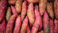 A pile of pink and yellow sweet potatoes