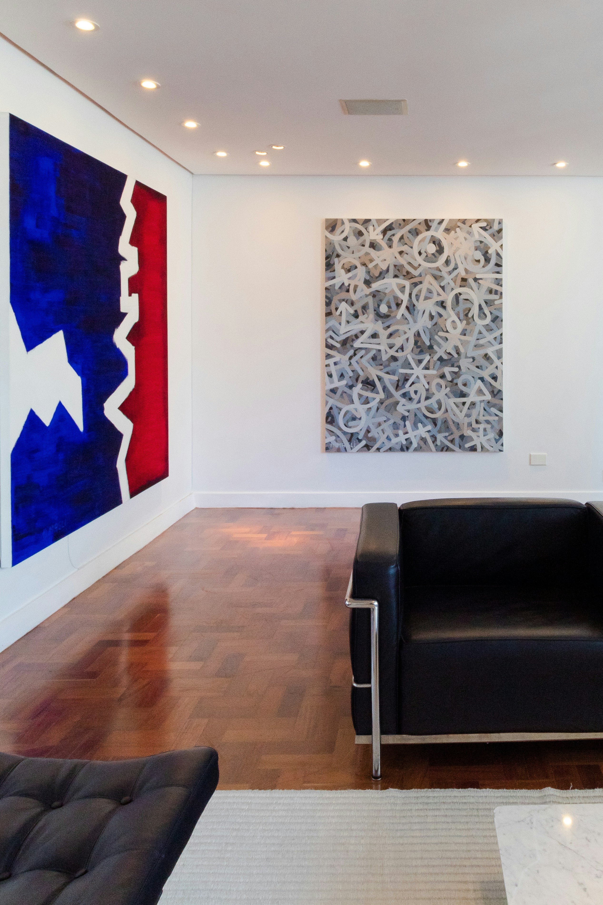 A living room filled with furniture and a painting on the wall