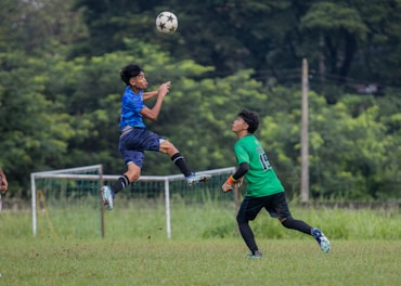 A group of young men playing a game of soccer