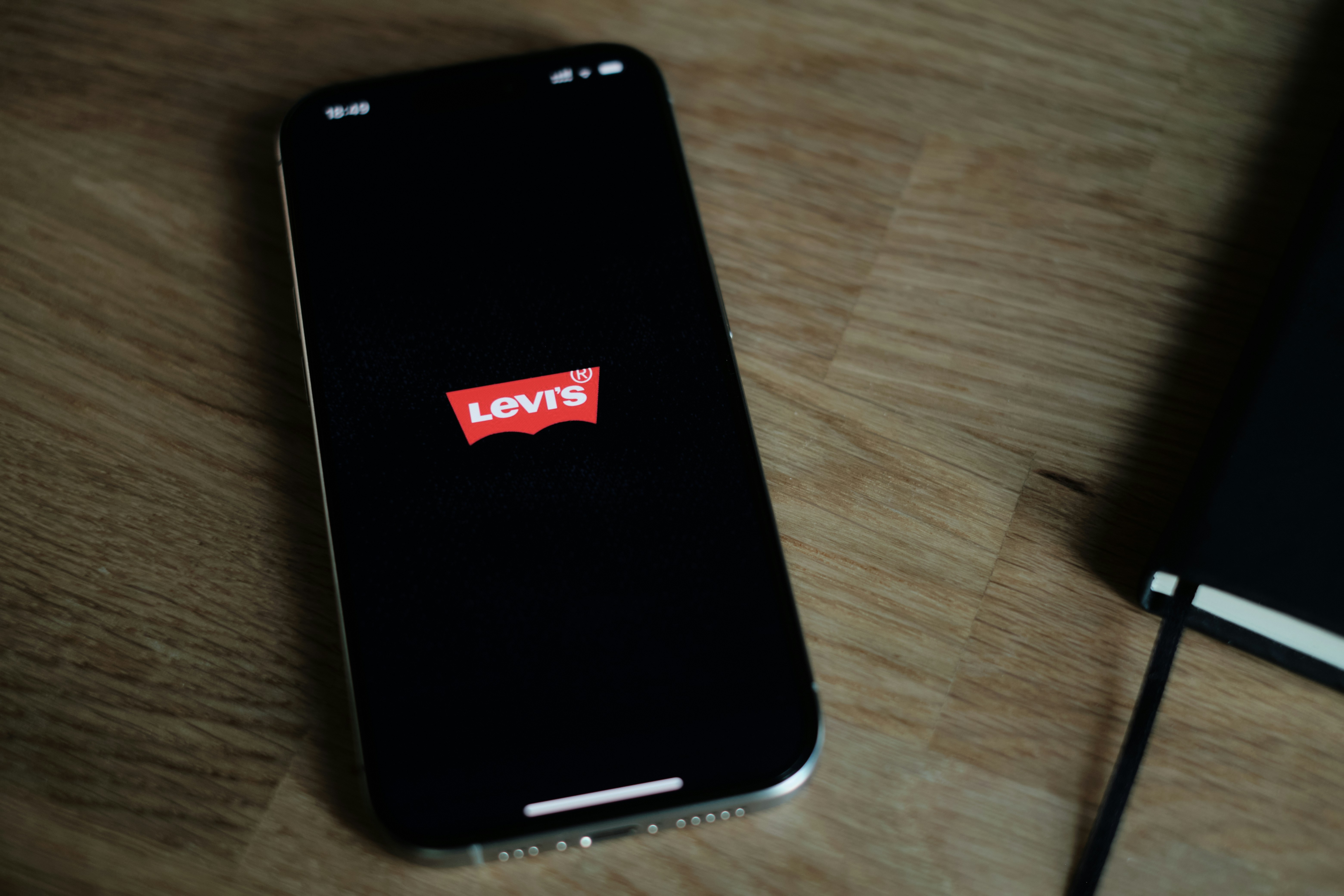 A cell phone sitting on top of a wooden table