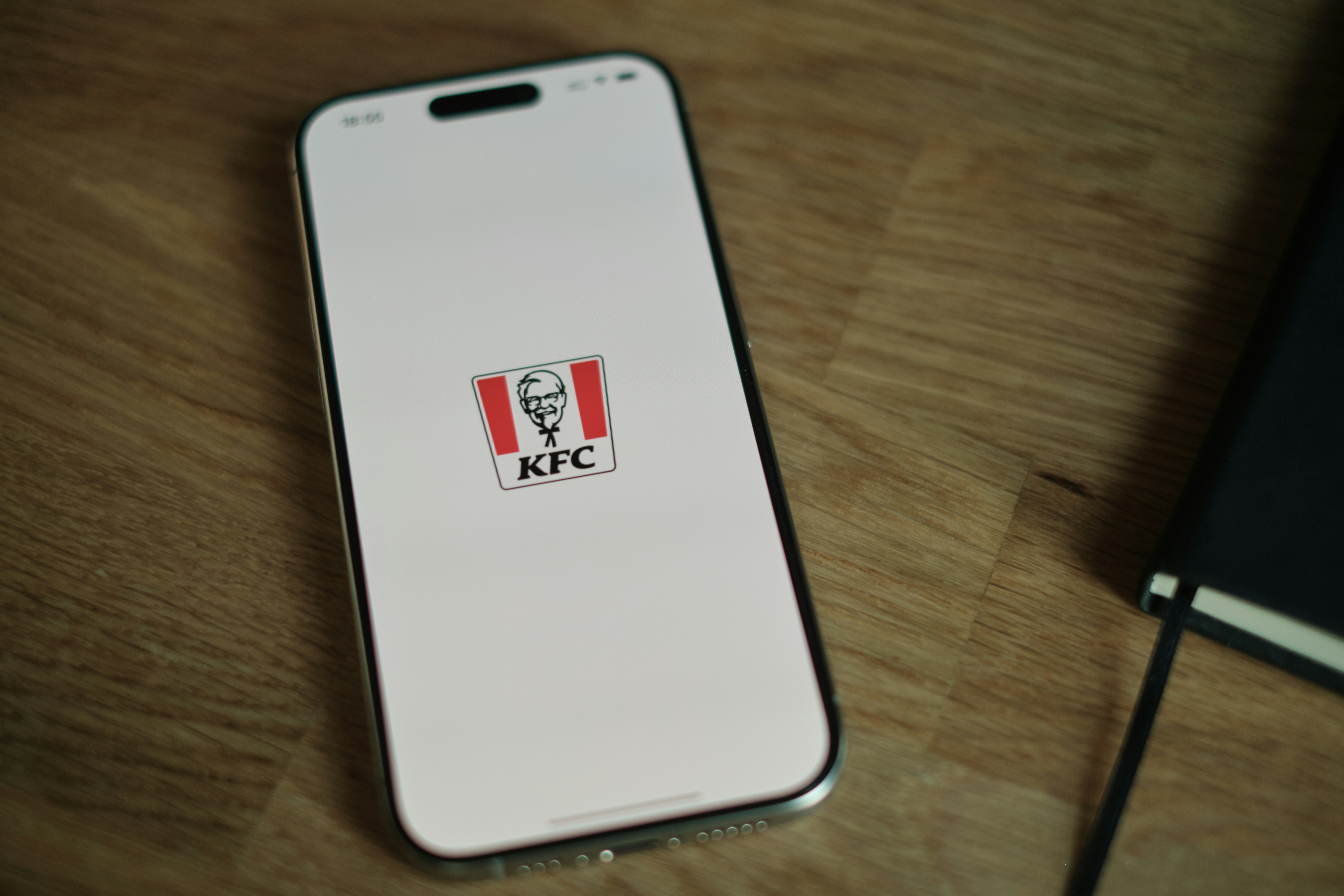 A cell phone sitting on top of a wooden table
