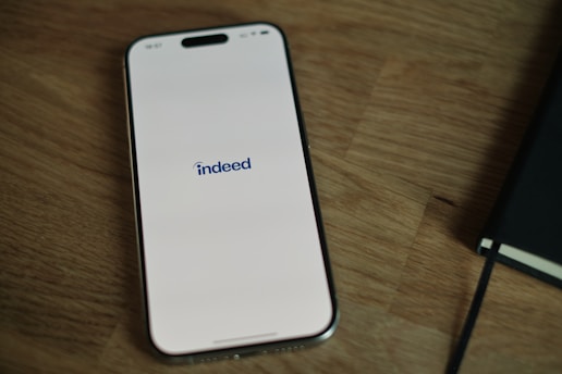 A cell phone sitting on top of a wooden table