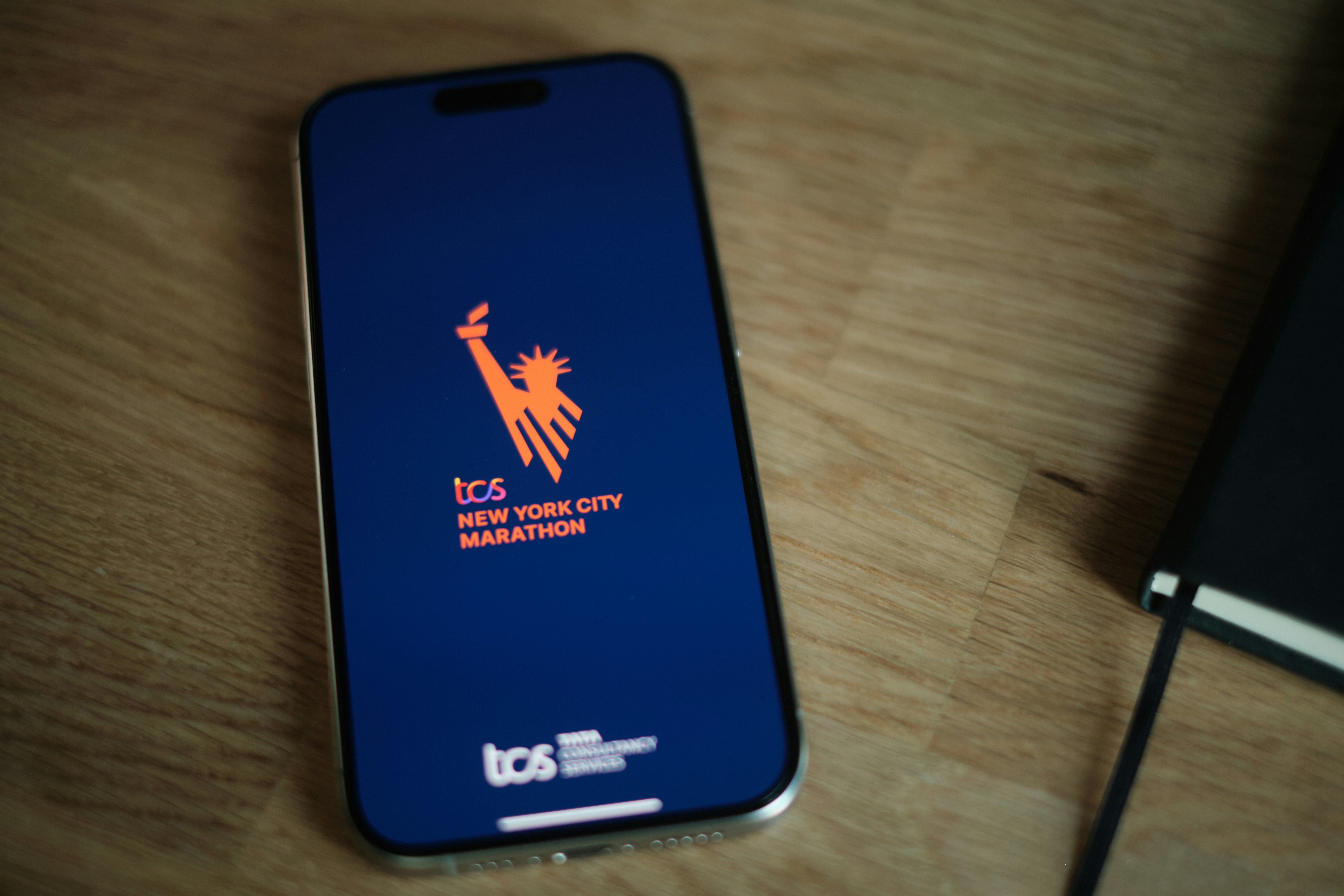 A cell phone sitting on top of a wooden table